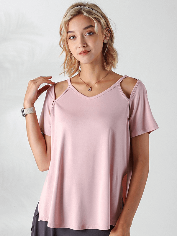Woman wearing a pink, loose hollow-out shoulders t-shirt, ideal for running and fitness, showcasing breathable, elastic fabric.